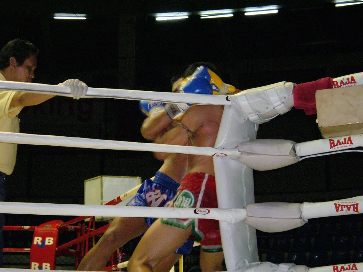 A Muay Thai fighter delivering an elbow strike in the ring at Rajadamnern Stadium