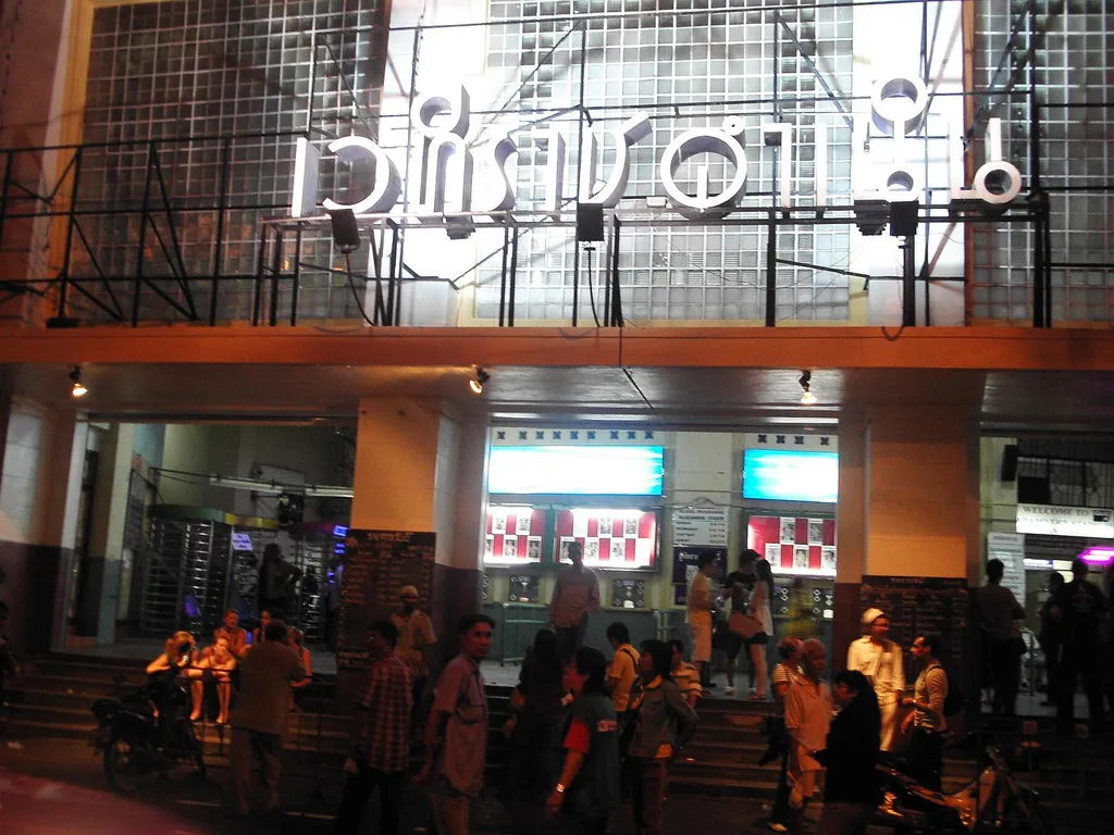 The illuminated entrance sign of Rajadamnern Stadium at night